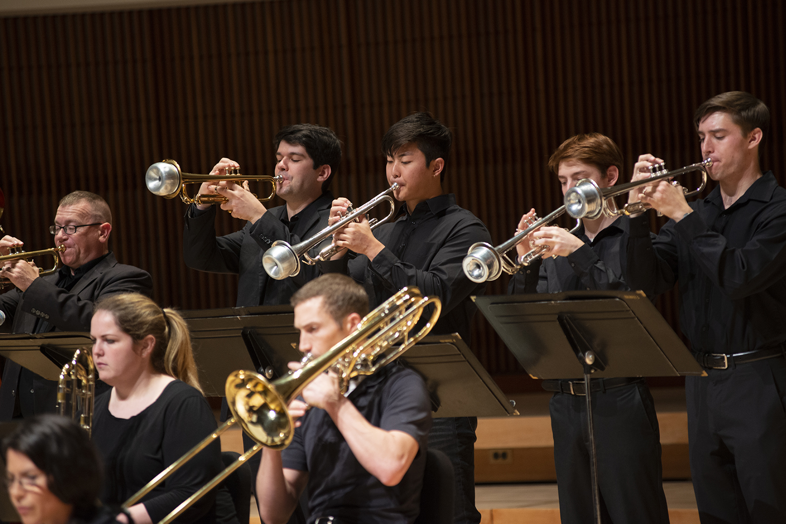 Members of the UMD Jazz Ensemble play trumpets during a concert.